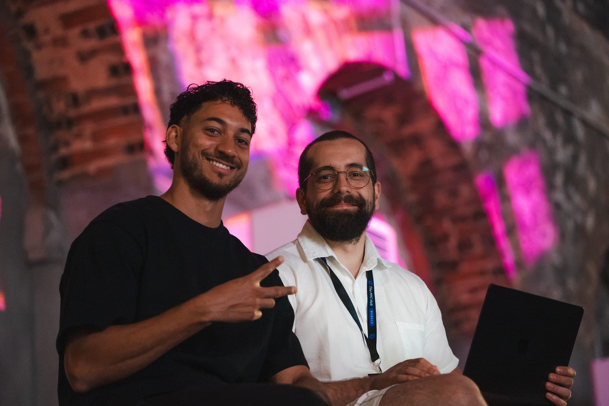 Two attendees smiling in front of the stage lights at LX Factory