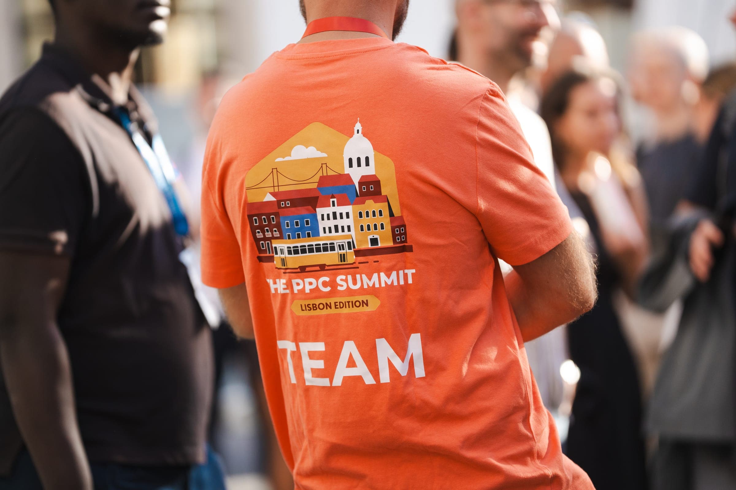 A crew member in the orange Lisbon edition team shirt
