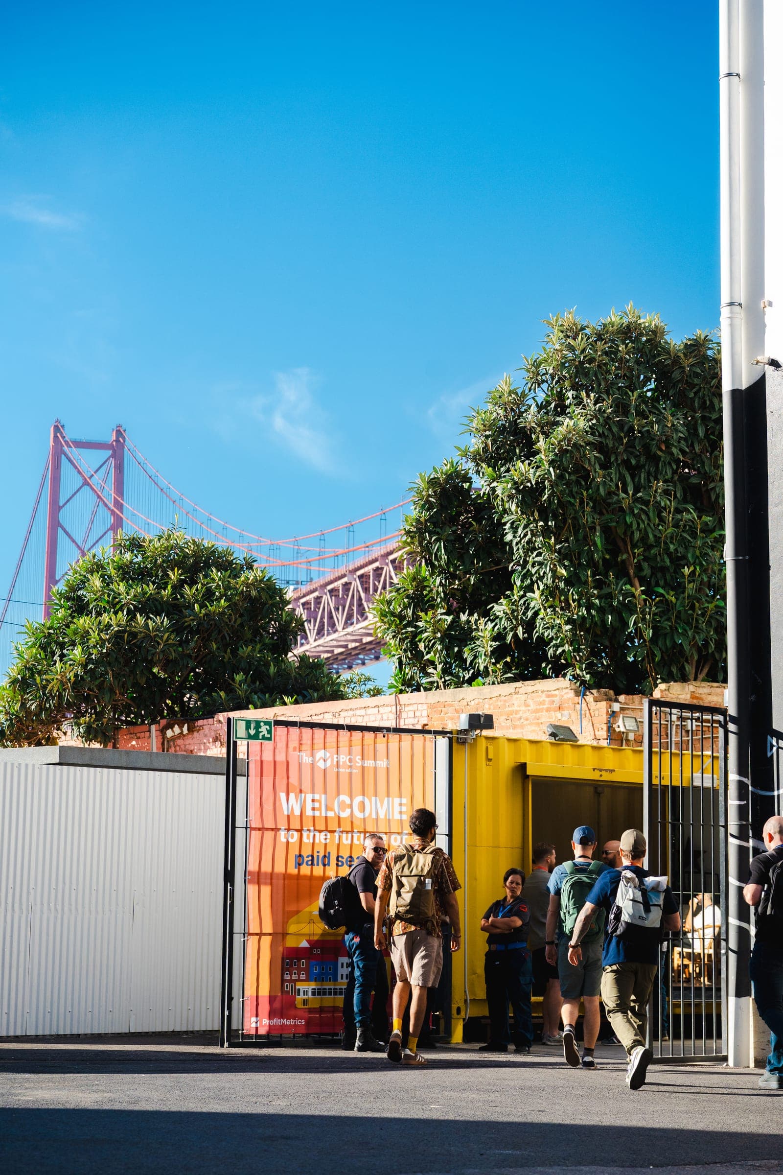 The PPC Summit welcome sign at the LX Factory entrance, under the 25 de Abril bridge